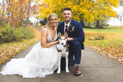 Newlywed couple with their husky
